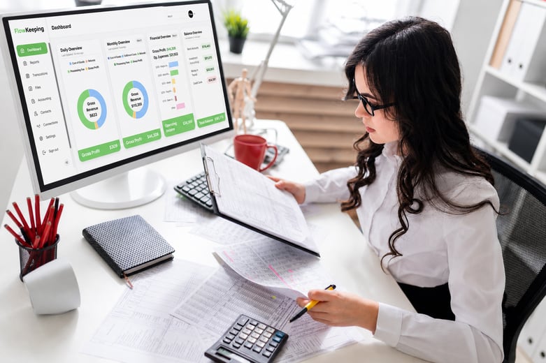 Flow Keeping bookkeeper helping an ecommerce business owner review financial details